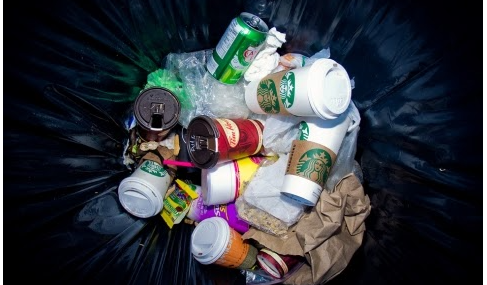 Bin full of rubbish and takeaway cups